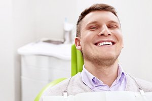 Smiling man sitting in dental office