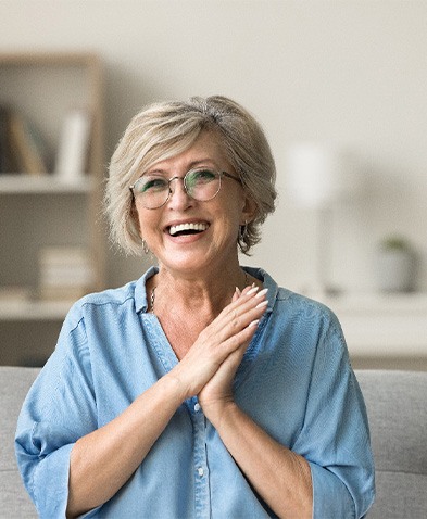 Happy senior woman sitting on sofa