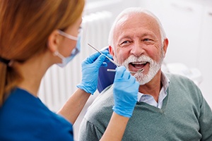 Man smiles at dentist