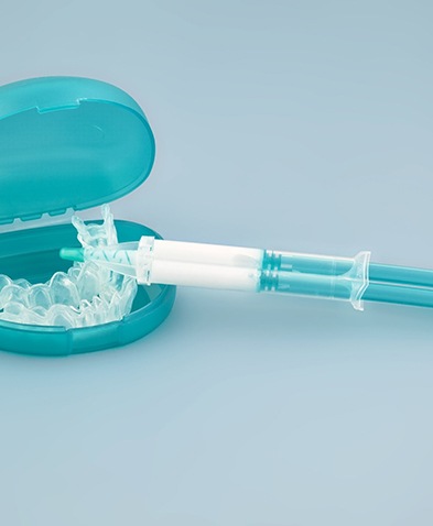 Take-home teeth whitening kit on blue background